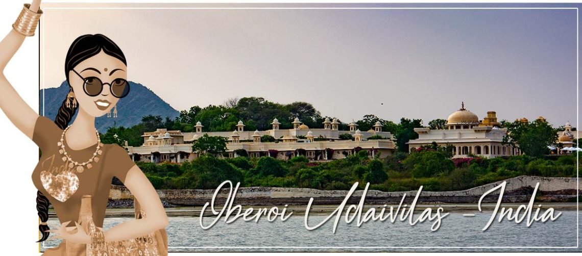 one of the best hotels in the world lakeside in udaipur with the sandstone and marble glistening as the sun sets over the mountains